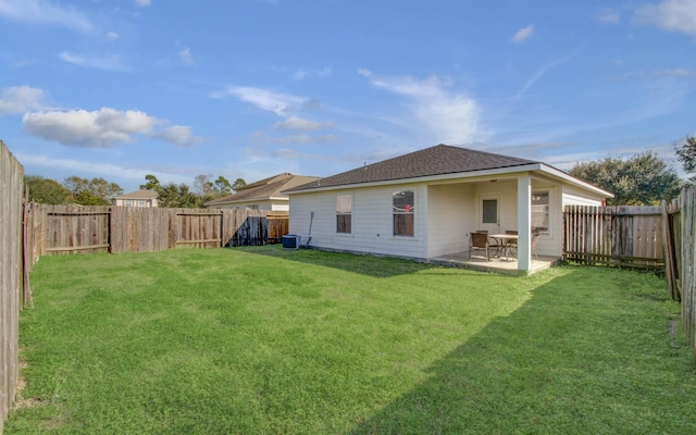 rear view of house with a patio and a lawn