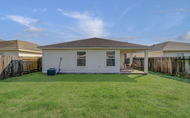 back of property with cooling unit, a yard, and a patio