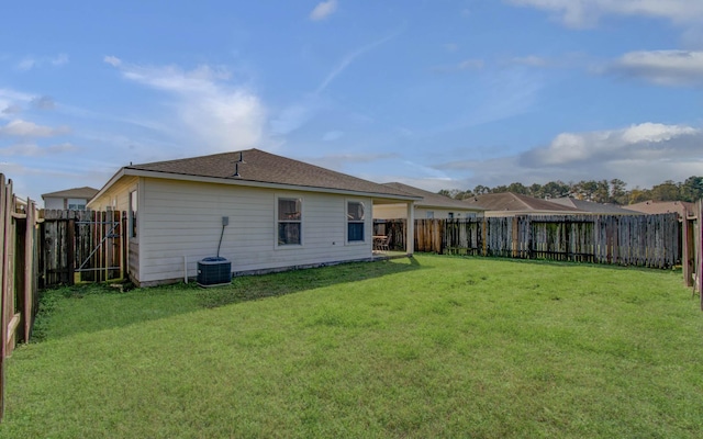 rear view of house featuring a yard