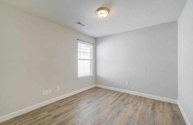 unfurnished room with light wood-type flooring