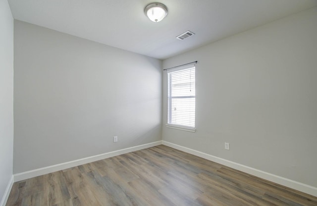 unfurnished room featuring wood-type flooring