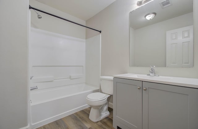 full bathroom with shower / bath combination, vanity, wood-type flooring, and toilet