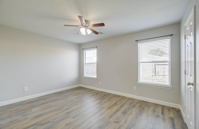 empty room featuring ceiling fan and light wood-type flooring