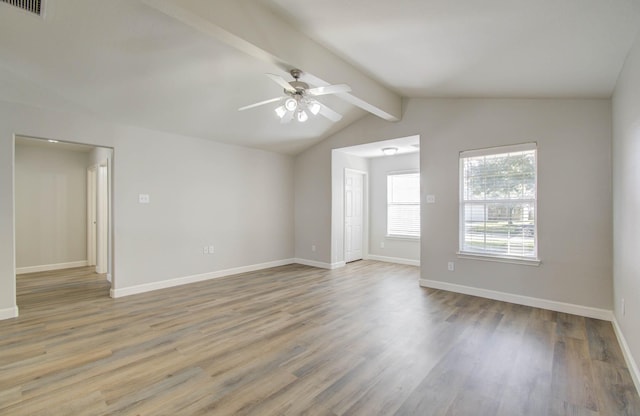 empty room featuring vaulted ceiling with beams, ceiling fan, and light hardwood / wood-style floors