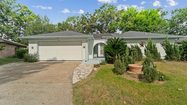 ranch-style house featuring a garage and a front yard