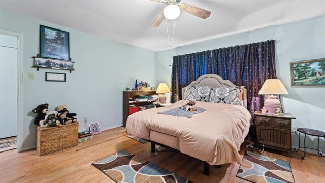 bedroom with light wood-type flooring and ceiling fan