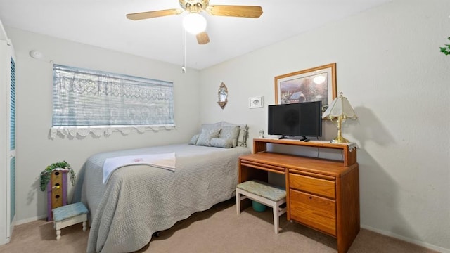 bedroom featuring ceiling fan and light carpet