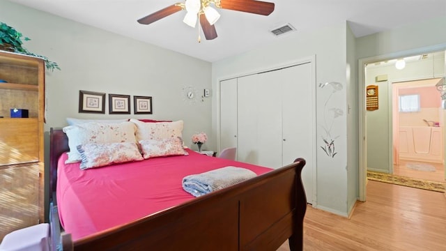 bedroom featuring ceiling fan, light hardwood / wood-style floors, and a closet