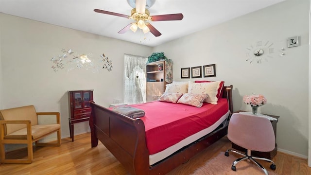 bedroom with light hardwood / wood-style floors and ceiling fan