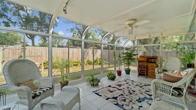 sunroom with rail lighting and ceiling fan