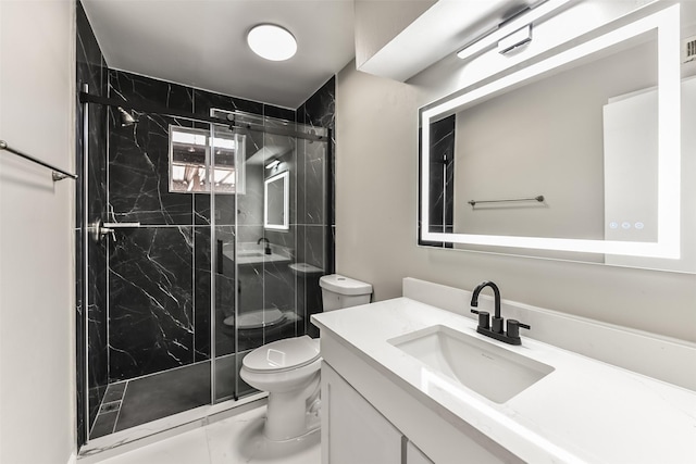 bathroom featuring a shower with door, vanity, and toilet