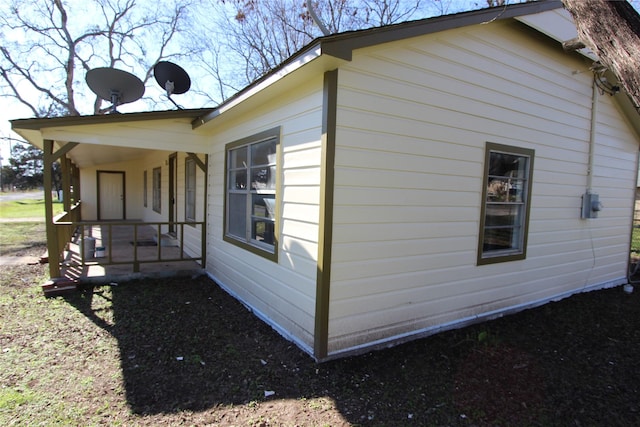 view of side of property with covered porch