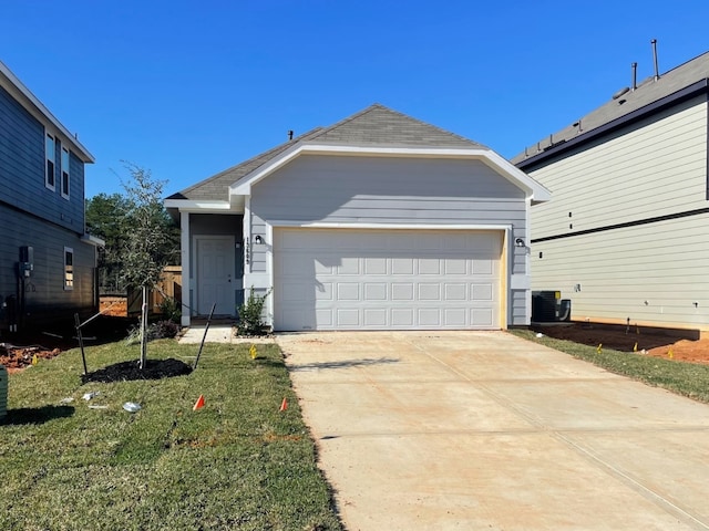 view of front of home featuring central air condition unit, a front lawn, and a garage