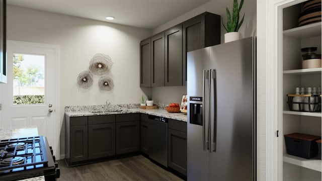 kitchen featuring light stone countertops, dark hardwood / wood-style flooring, stainless steel appliances, and sink