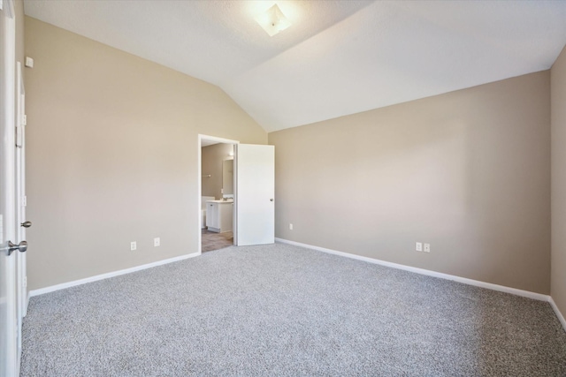 unfurnished bedroom with carpet floors and lofted ceiling