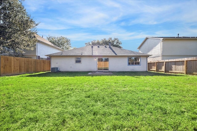 back of property with a lawn and central air condition unit