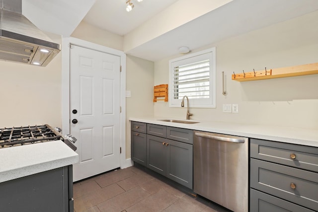 kitchen featuring sink, stainless steel dishwasher, ventilation hood, stove, and gray cabinets