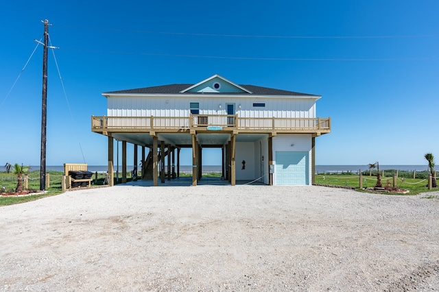 raised beach house featuring a garage