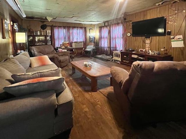 living room with hardwood / wood-style floors and wooden walls