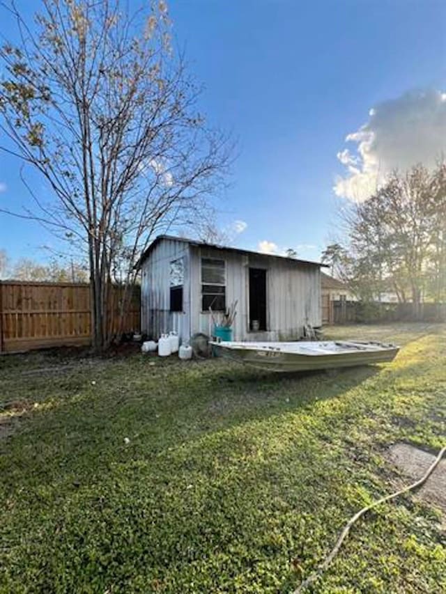 view of outbuilding featuring a yard