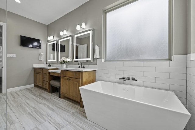 bathroom featuring a bath and vanity