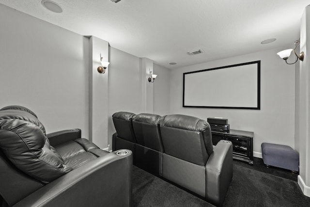 cinema room featuring dark carpet