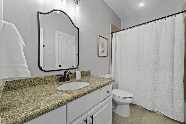 bathroom with tile patterned floors, vanity, and toilet