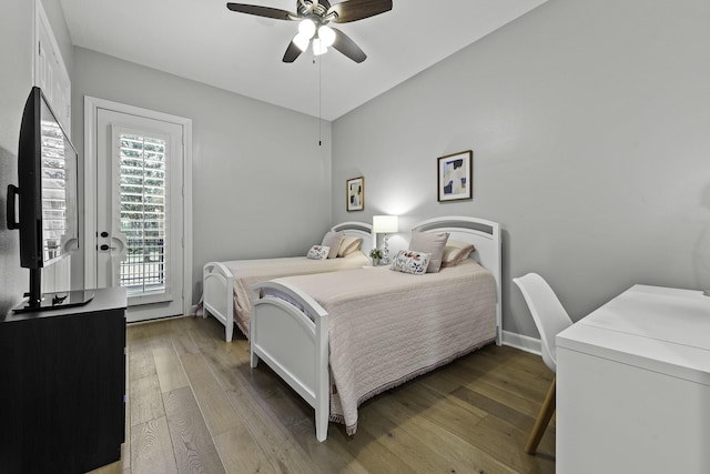 bedroom with ceiling fan, access to outside, hardwood / wood-style floors, and multiple windows