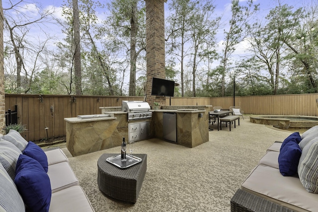 view of patio featuring exterior kitchen, an outdoor living space, and area for grilling