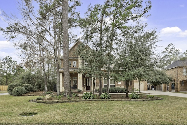 view of front of property featuring a front lawn and a garage