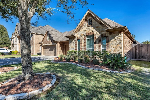 view of front of home featuring a front yard and a garage