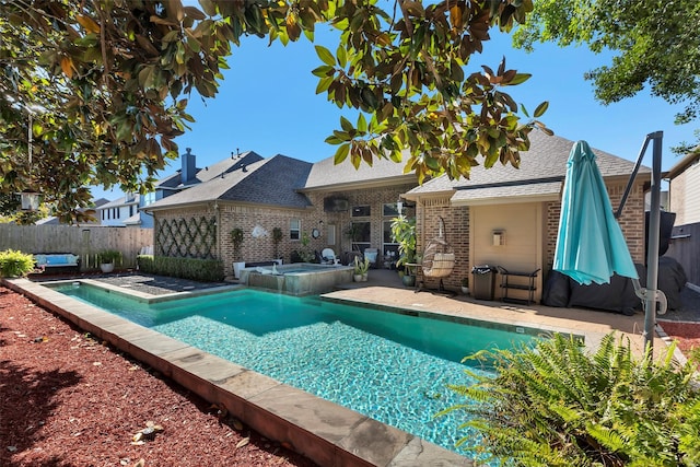 view of pool with an in ground hot tub