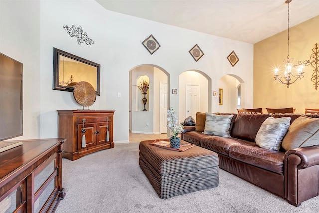 carpeted living room with a chandelier