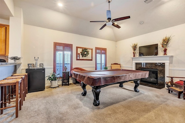 rec room with lofted ceiling, ceiling fan, a fireplace, pool table, and light colored carpet