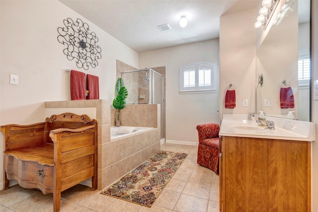 bathroom with plus walk in shower, tile patterned flooring, vanity, and a textured ceiling