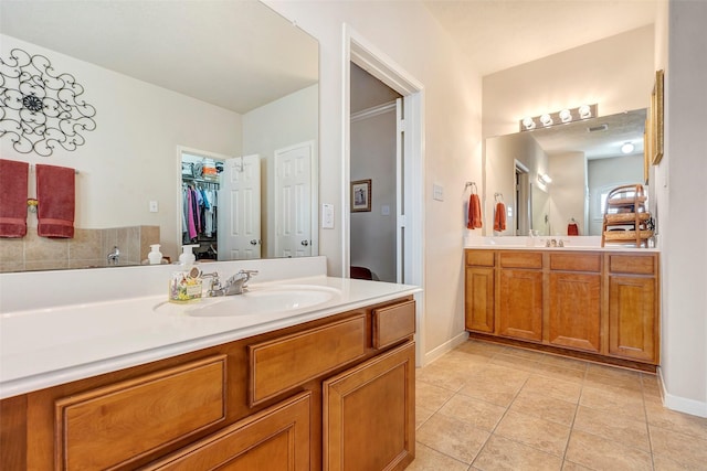 bathroom featuring tile patterned flooring and vanity