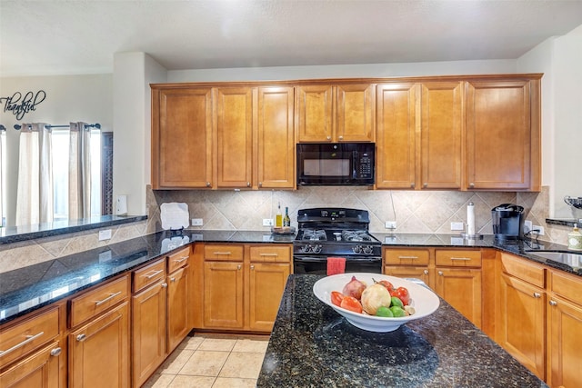 kitchen with black appliances, decorative backsplash, dark stone countertops, and light tile patterned floors