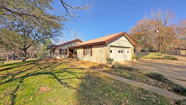 view of home's exterior with a yard and a garage