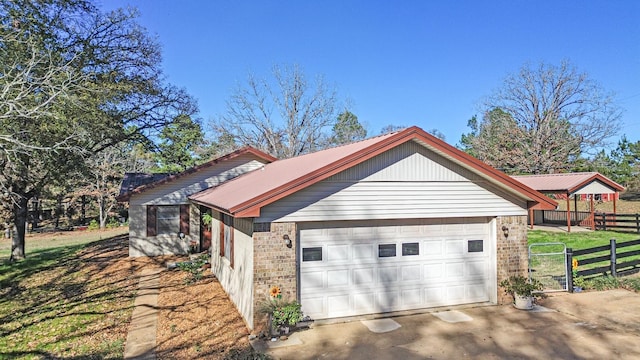 view of property exterior featuring a garage and a lawn