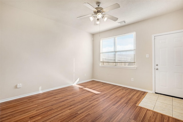 foyer featuring ceiling fan and wood-type flooring