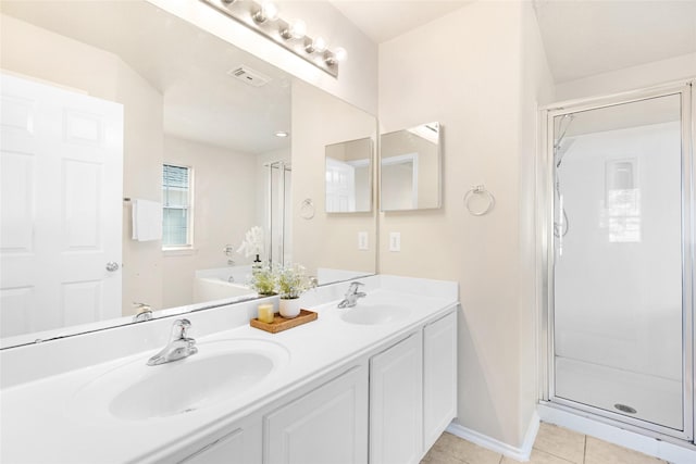 bathroom with vanity, tile patterned floors, and shower with separate bathtub