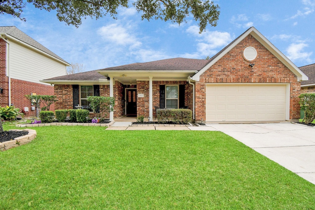 view of front of property with a garage and a front yard