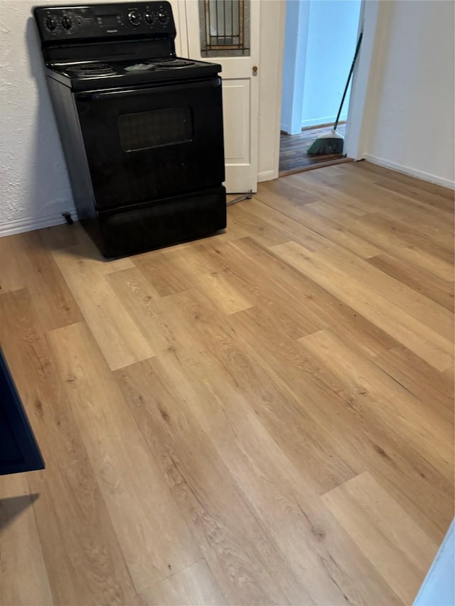 interior details featuring wood-type flooring and black / electric stove