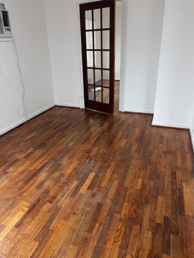 unfurnished room featuring dark wood-type flooring