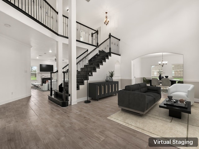 living room featuring a chandelier and a towering ceiling