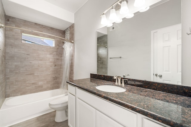 bathroom with visible vents, toilet, shower / tub combo, vanity, and wood finished floors