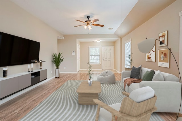 living room featuring ceiling fan and light hardwood / wood-style floors