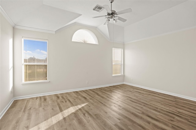 empty room with ceiling fan, light hardwood / wood-style flooring, vaulted ceiling, and ornamental molding