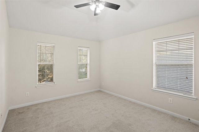 carpeted spare room featuring ceiling fan