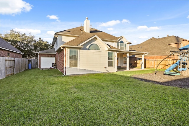 back of property featuring a patio area, a playground, and a yard